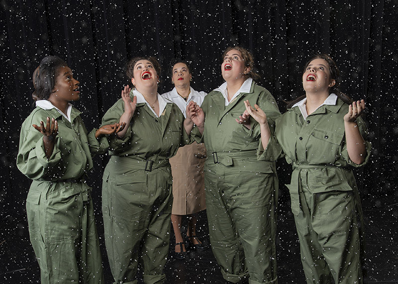 5 women in army green in the snow